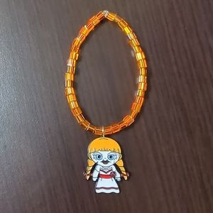 Halloween Orange beaded stretch bracelet with Annabelle Charm